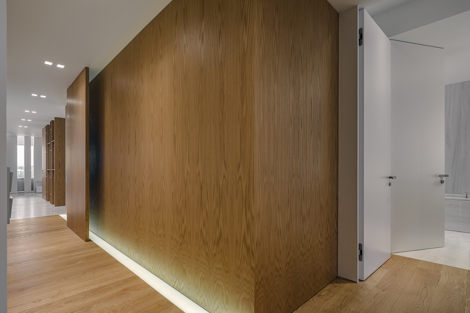 Inner lacquer doors with hidden hinge. Oak lining leading to a pivot door.